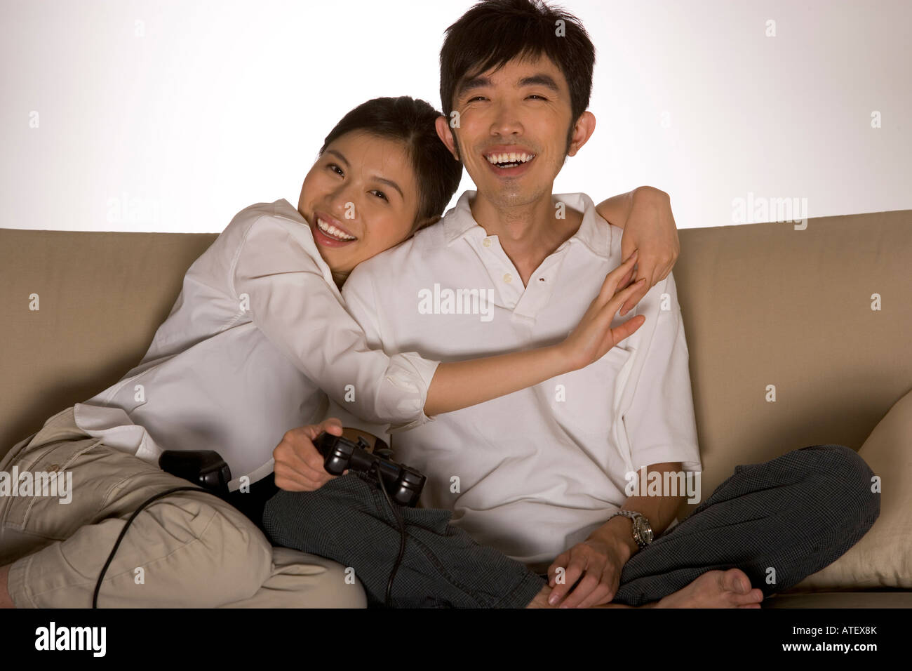 Portrait of a young woman embracing a young man Stock Photo - Alamy