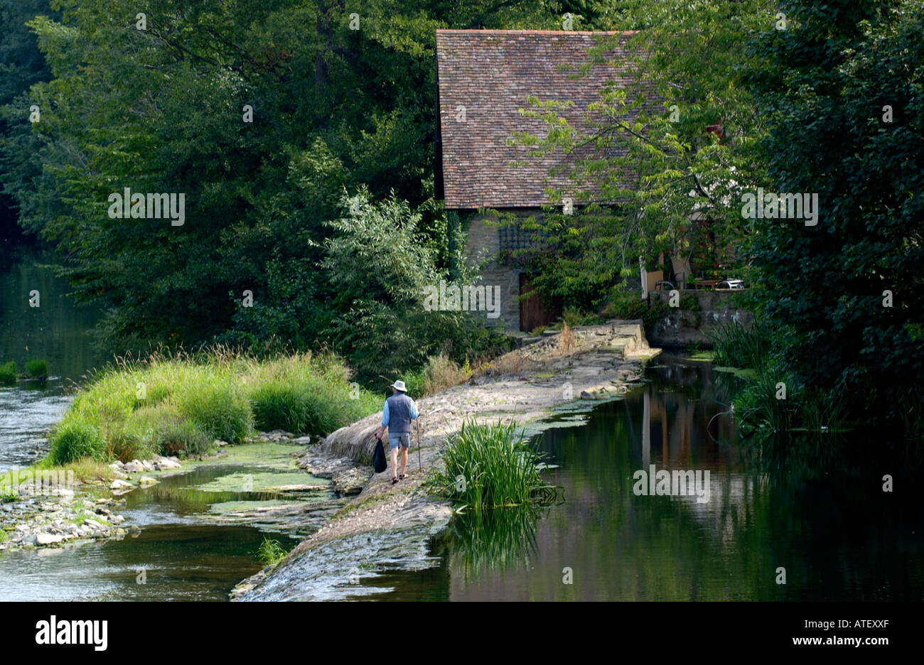 Man clearing litter from River Teme at Ludlow Shropshire England UK Stock Photo