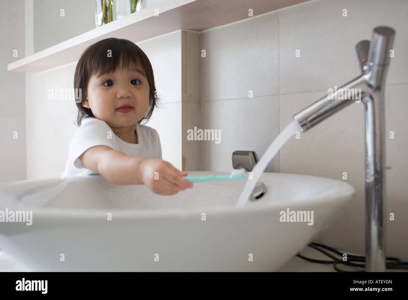 Child brushing teeth with water running Stock Photo Alamy