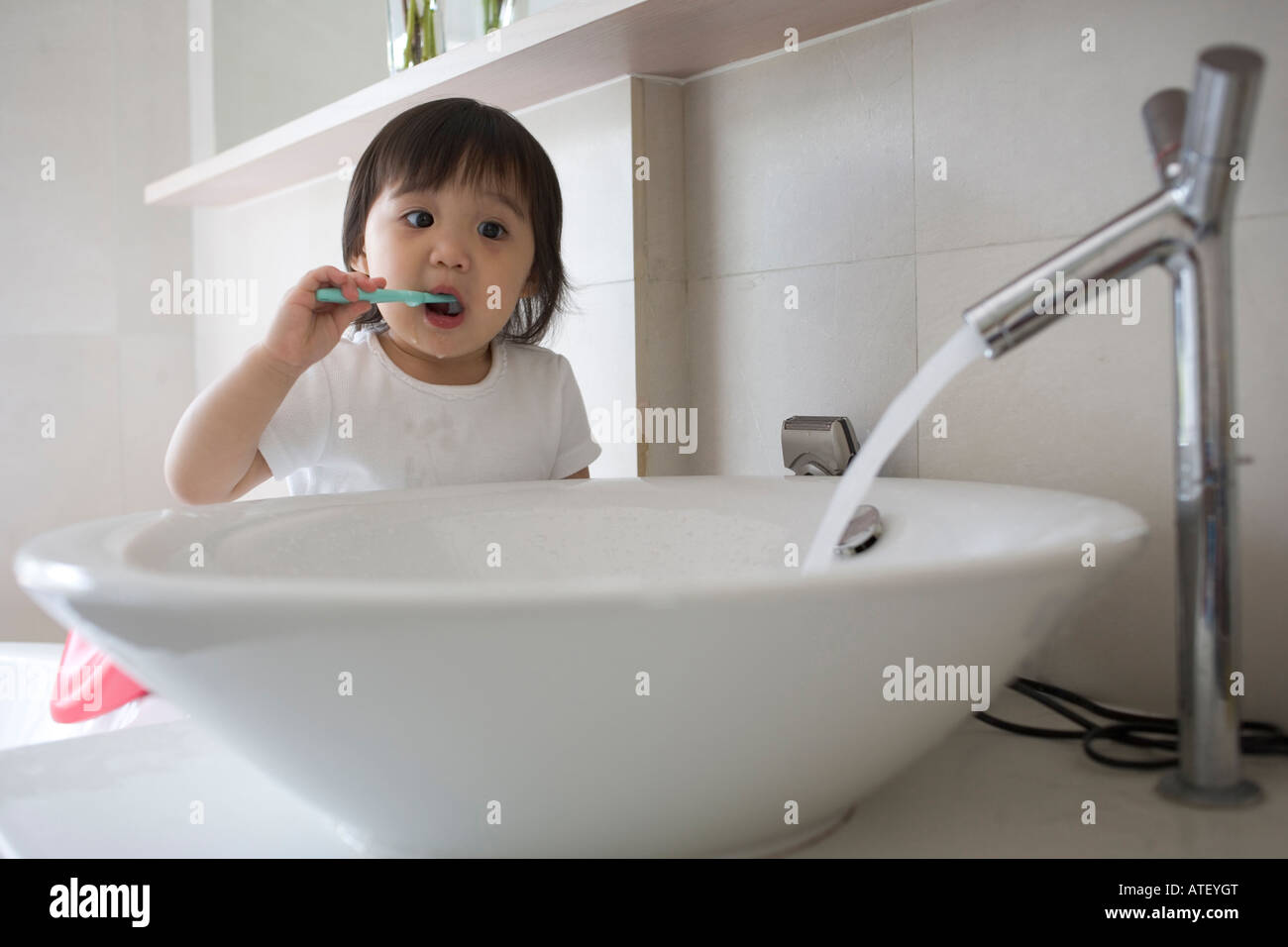 Child brushing teeth with water running Stock Photo Alamy