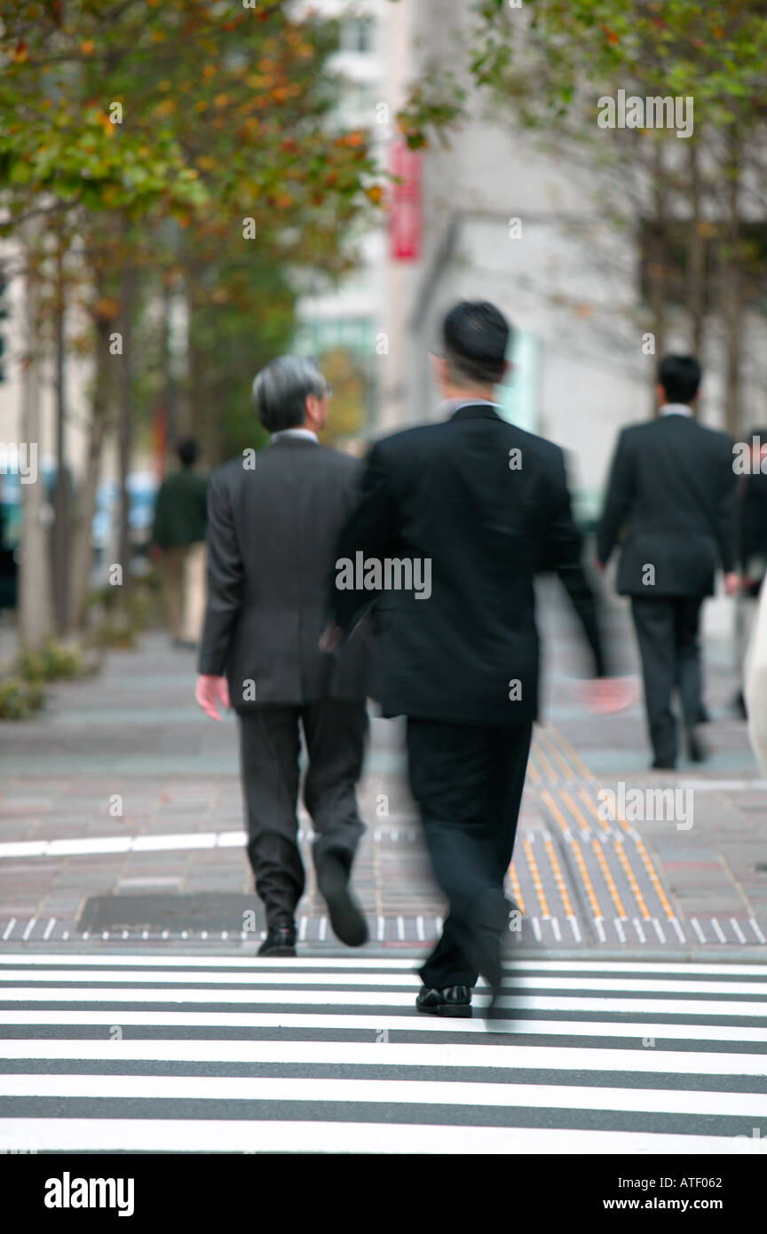 Businessmen walking on business district Marunouchi Ginza Tokyo Japan Stock Photo