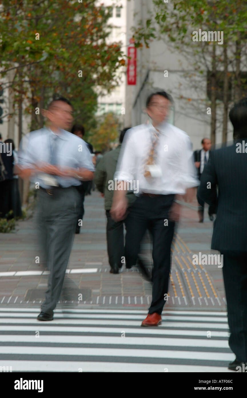 Businessmen walking on business district Marunouchi Ginza Tokyo Japan Stock Photo