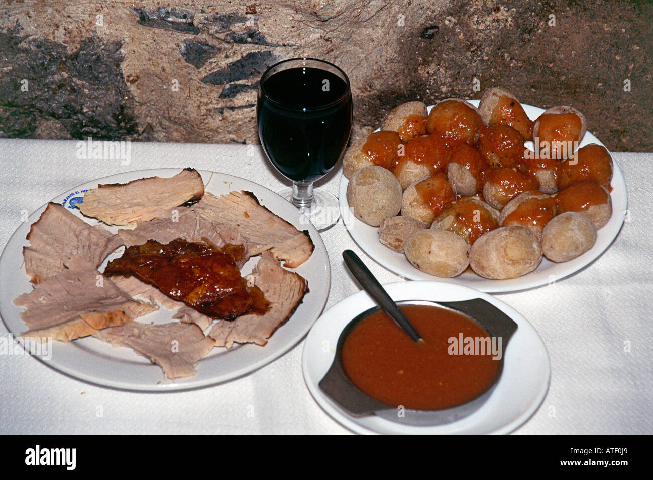 Plate of Arrugadas with Moho sauce and roast pork Stock Photo