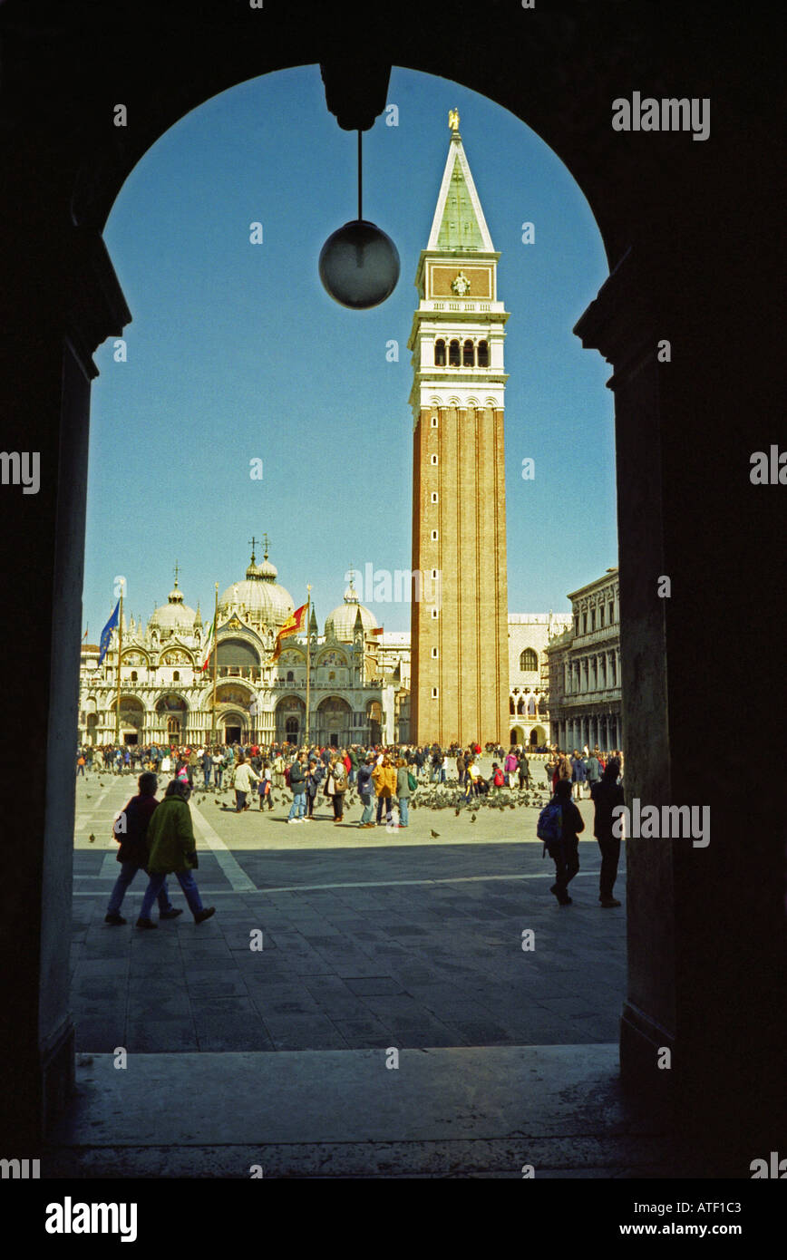 Imposing cathedral & bell tower Saint Mark Square from underneath a portico Venice Veneto Northeast Northern Italy Europe Stock Photo