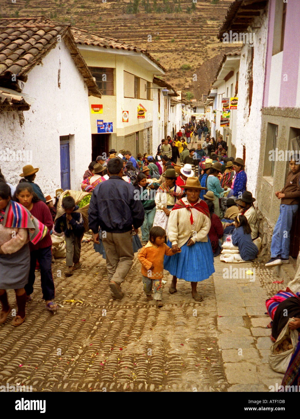 Indigenous people in traditional clothing march through streets after