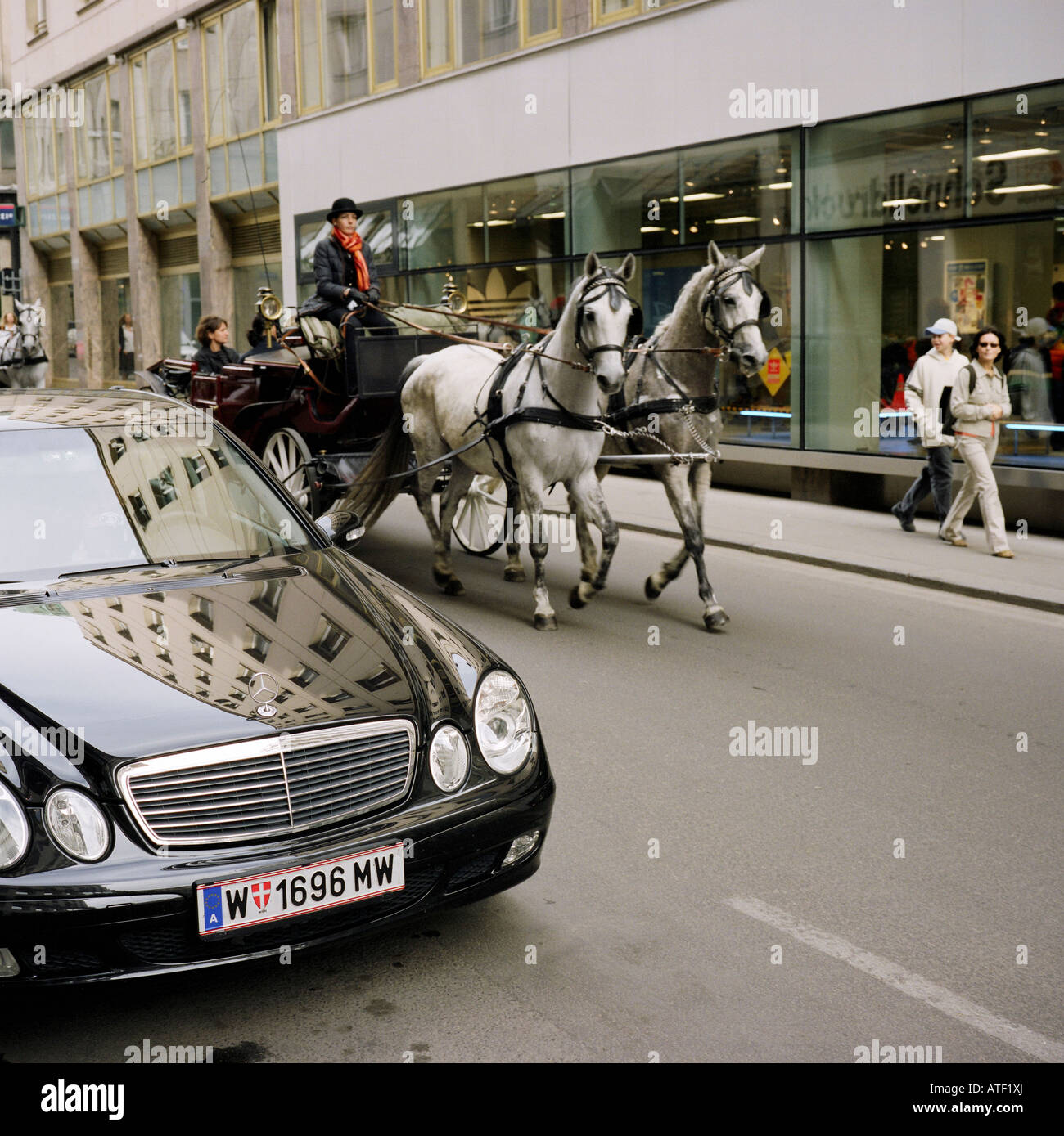 A Horse Drawn Carriage And A Mercedes Benz In The Street Vienna Austria Stock Photo Alamy