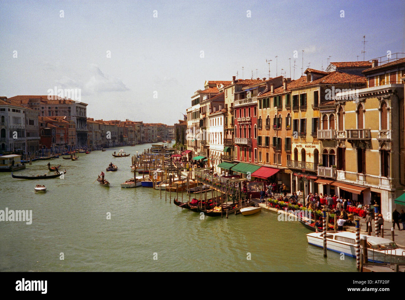 Colourful gondolas boat navigate tourist restaurant café river Great Channel Venice Veneto Northeast Northern Italy Europe Stock Photo
