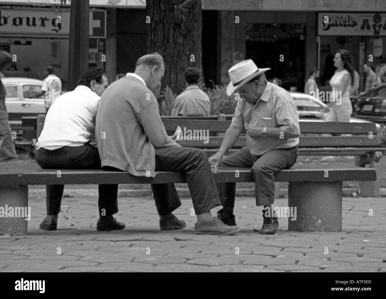 Group senile men playing cards public bench in central boulevard Florianopolis Santa Catarina Brazil Brasil South Latin America Stock Photo