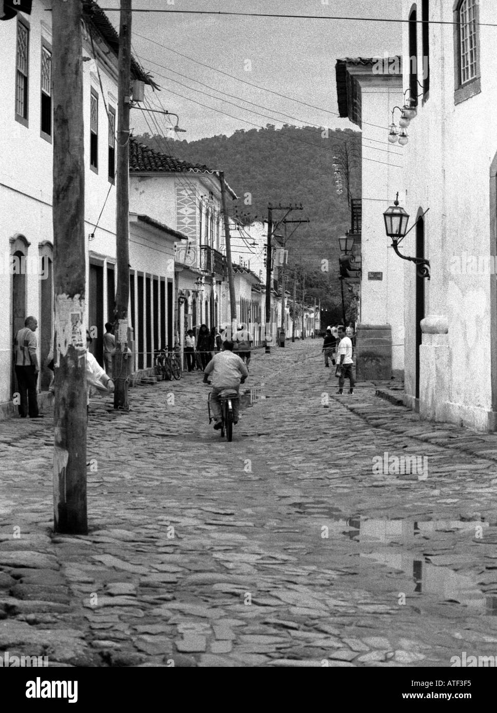 Animated street scene people socializing sit doorsteps of colonial town Paraty Rio de Janeiro Brazil Brasil South Latin America Stock Photo