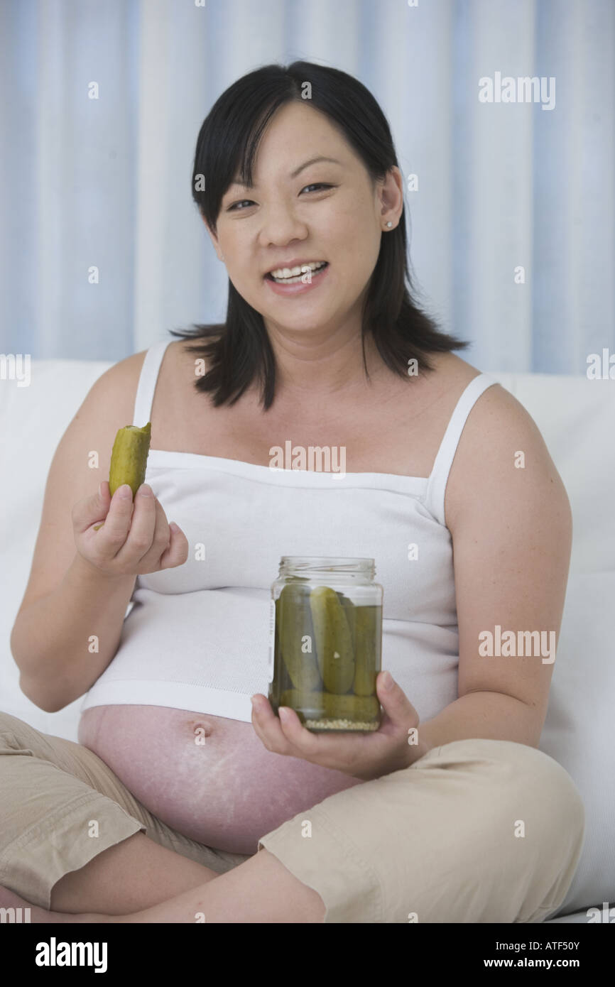 Portrait of a pregnant woman eating pickles from a jar Stock Photo Alamy