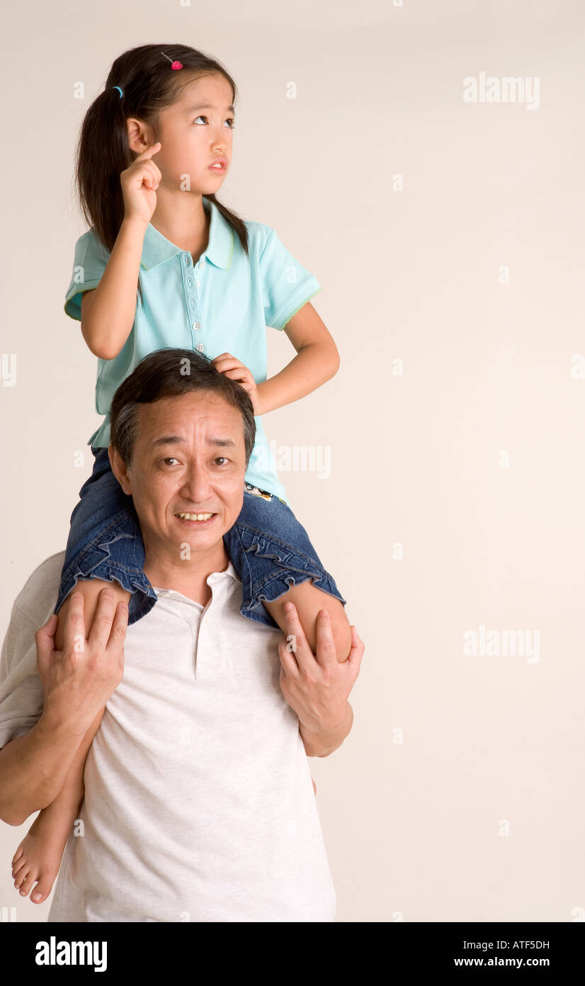 Grandfather Carrying Granddaughter On Shoulders Hi res Stock Grandfather Carrying Granddaughter On Shoulders Hi res Stock