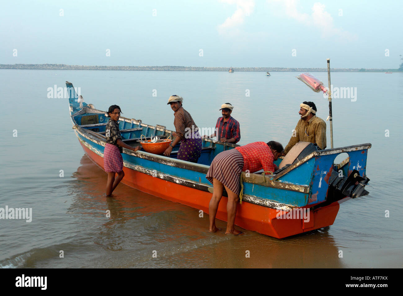 local indian fishing boat and fishermen with catch at kollam Stock