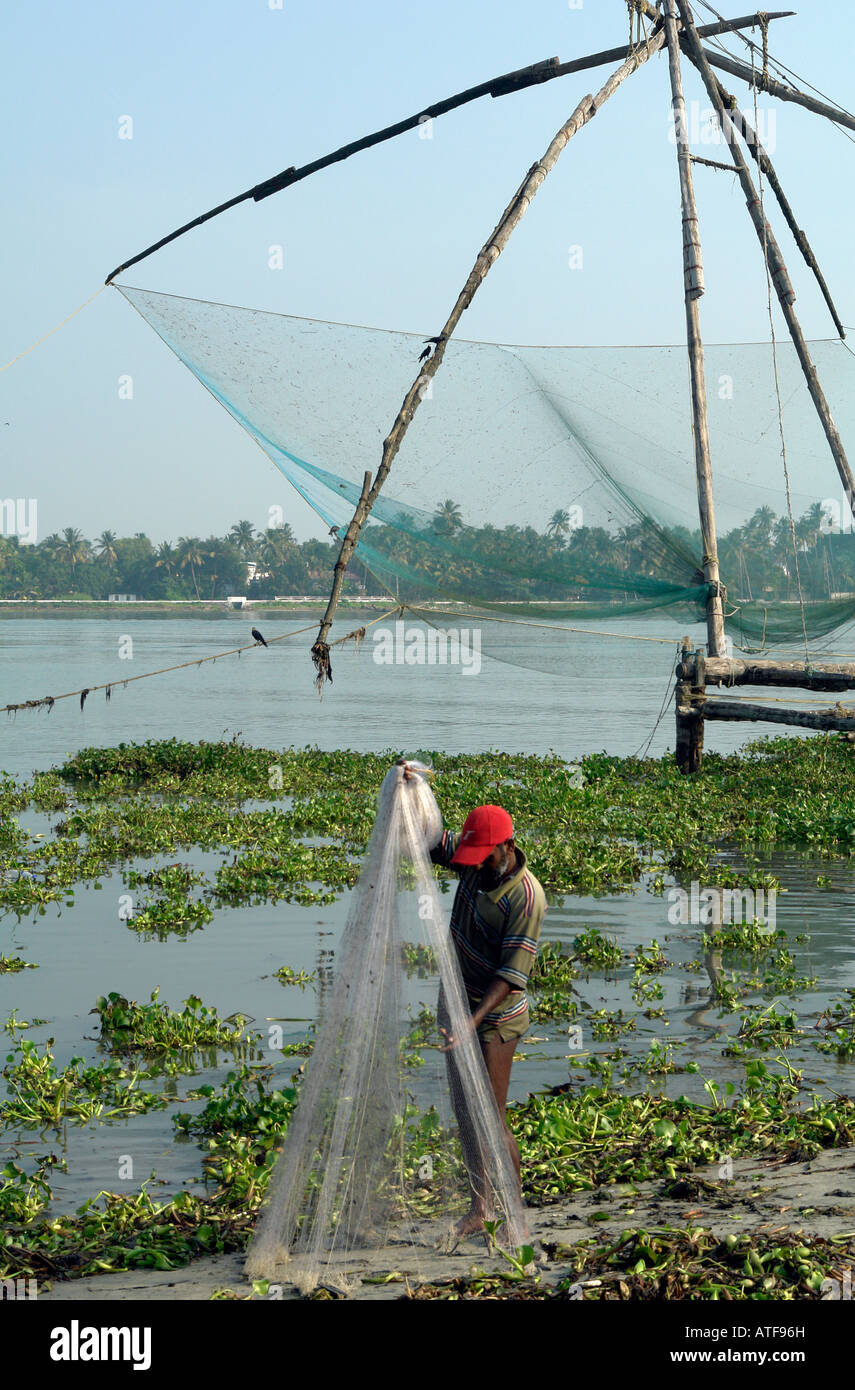 local indian fisherman with traditional throw net at the chinese fishing  nets at kochi india Stock Photo - Alamy