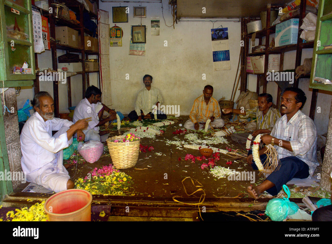 making flower garlands in the market at coimbatore india Stock Photo