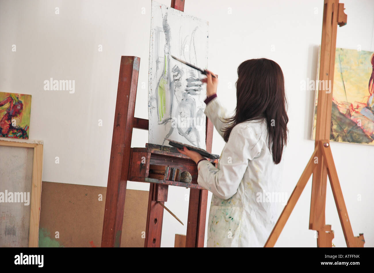 Young female art student painting Stock Photo - Alamy