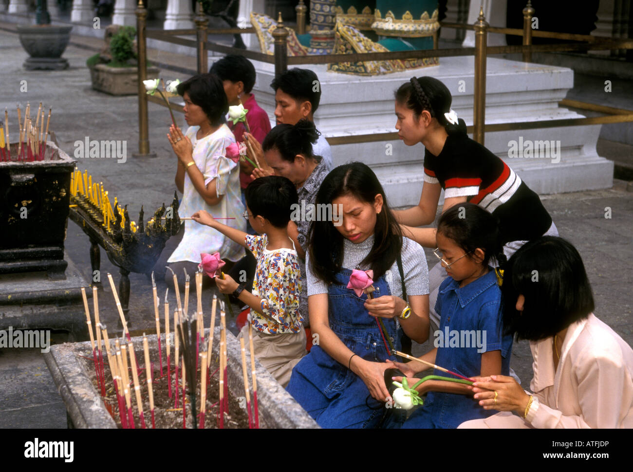 Thai people, making offering, prayer, praying, Wat Phra Si Ratana Sasadaram, Wat Phra Kaeo, Bangkok, Bangkok Province, Thailand, Southeast Asia, Asia Stock Photo