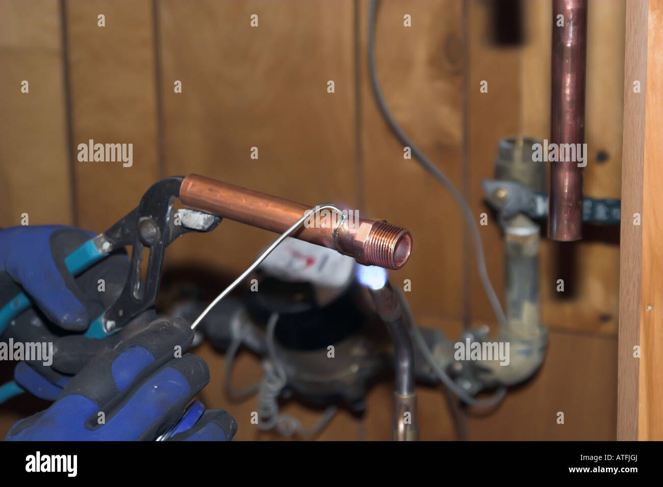 A plumber soldering copper pipe together Stock Photo Alamy