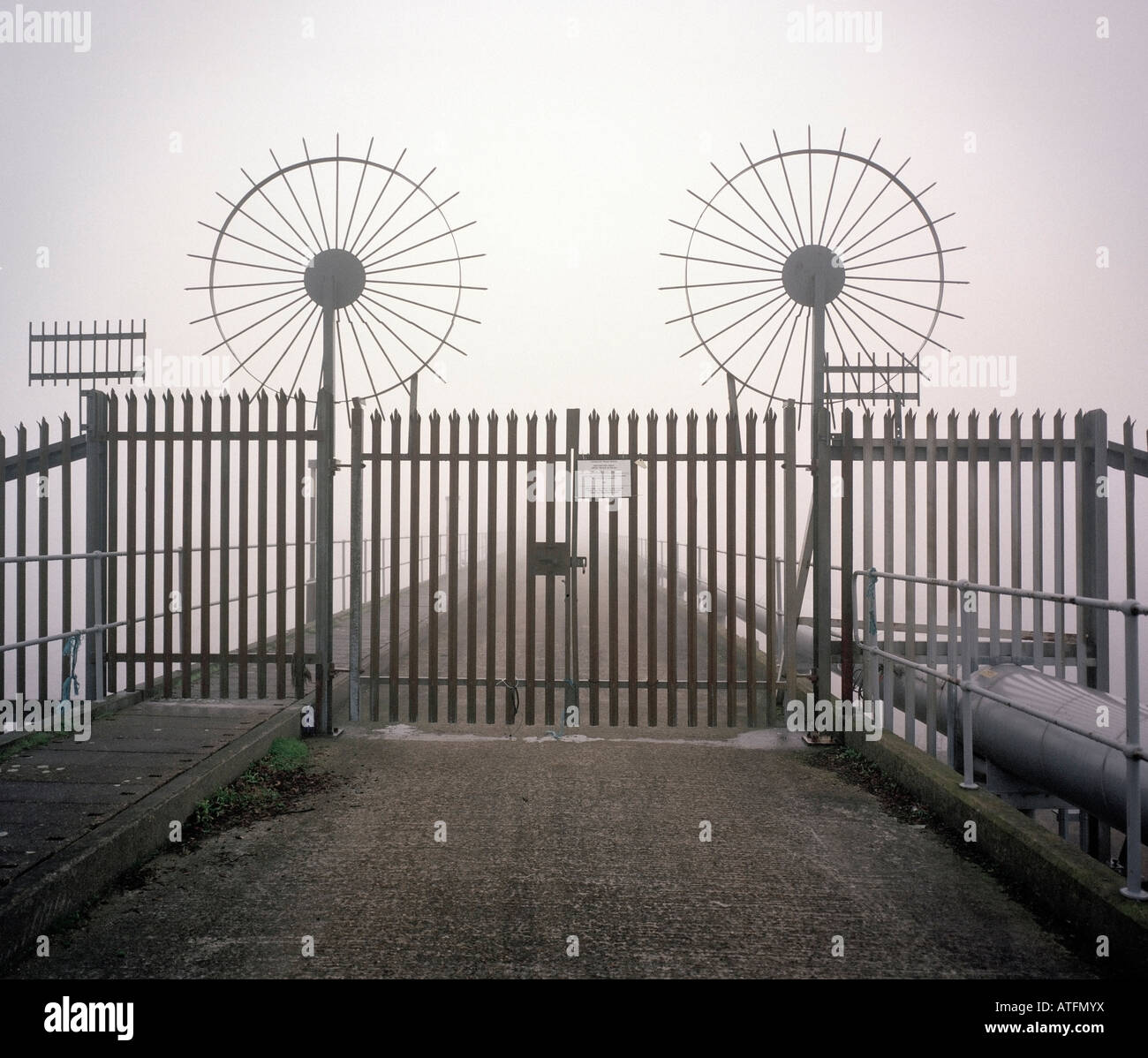 Galvanized gates with circular anti climb spikes London England UK Stock Photo