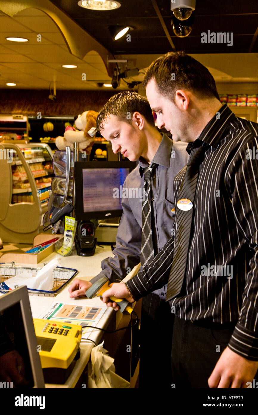 Store staff processing a Paypoint payment at a Convienence store Stock ...