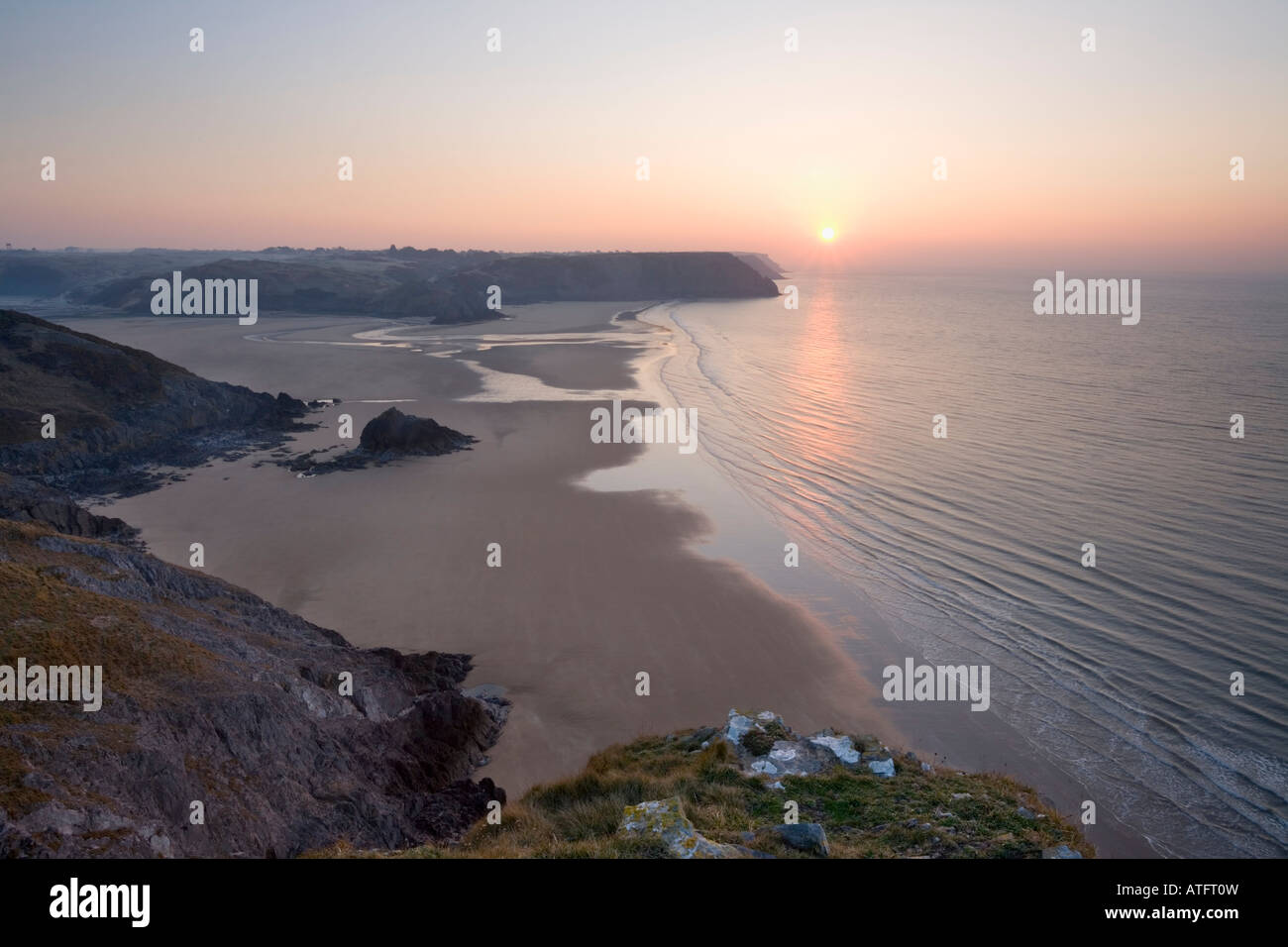 Three Cliffs Bay from Great Tor at Sunrise Gower Wales Stock Photo