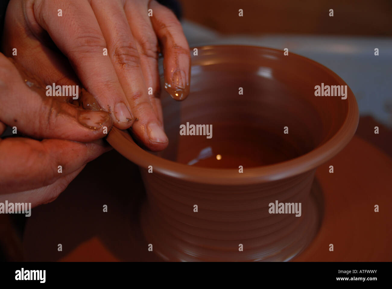 Potter throwing a pot on a wheel Stock Photo Alamy