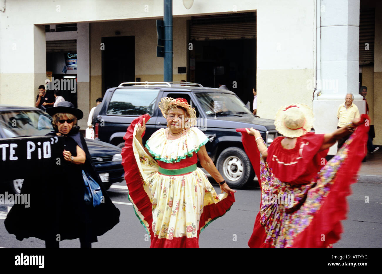Brightly coloured dresses of women dancing in the street, part of a procession. Guayaquil. Ecuador. Stock Photo