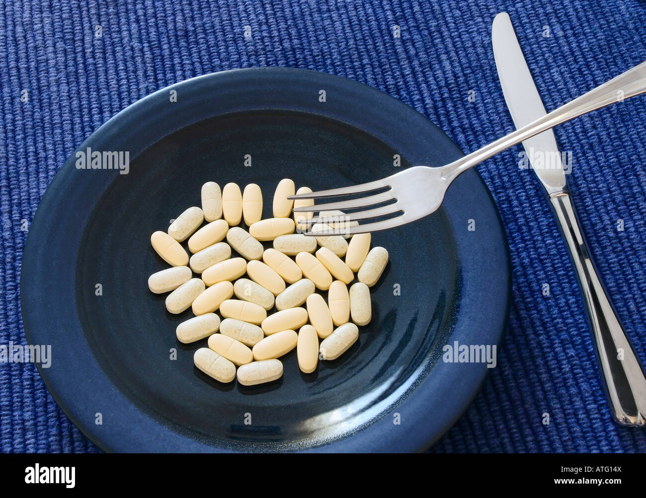 Vitamin supplements on a plate Stock Photo
