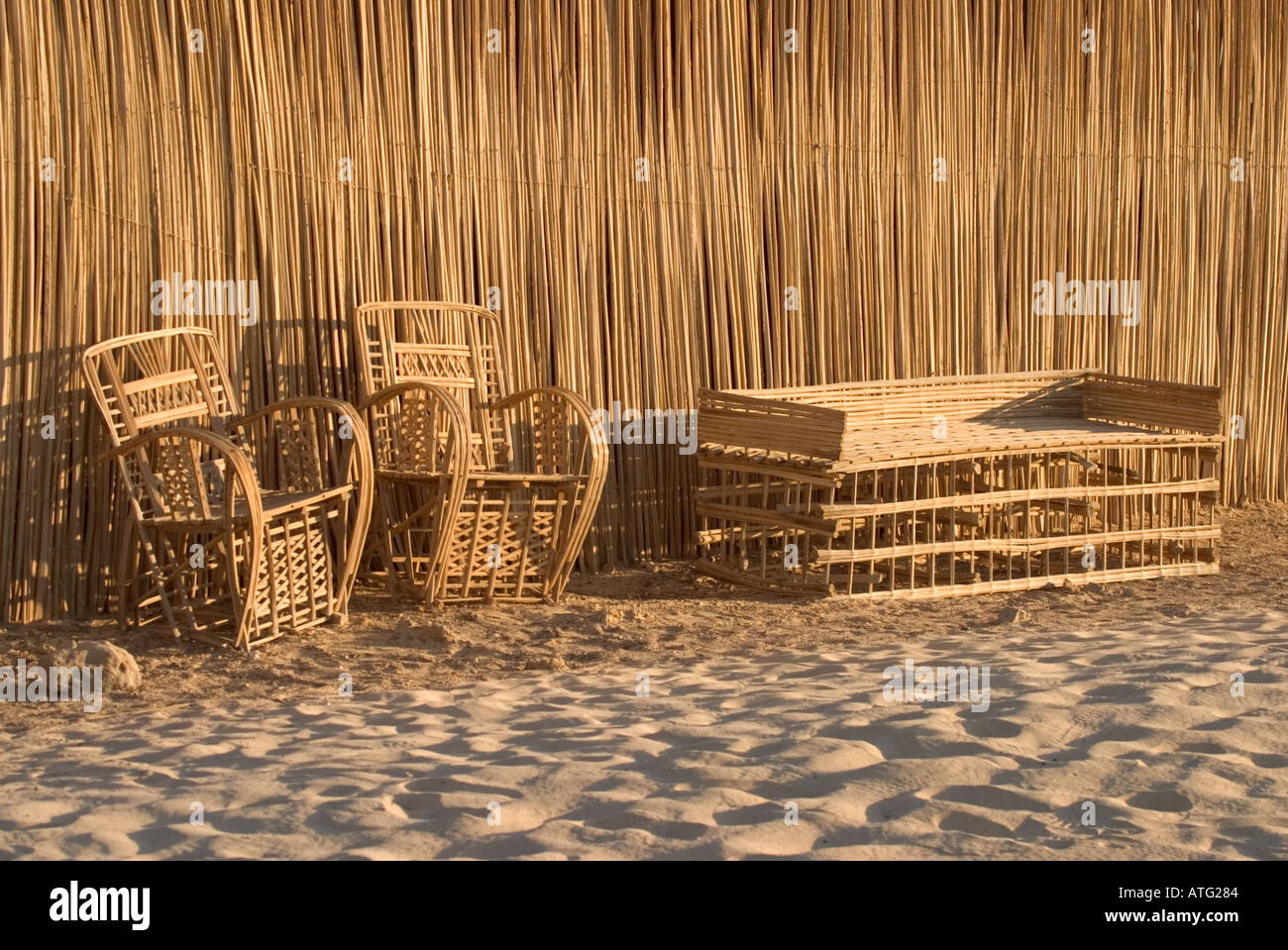 Wicker Chairs in Front of Reed Building Egypt Stock Photo