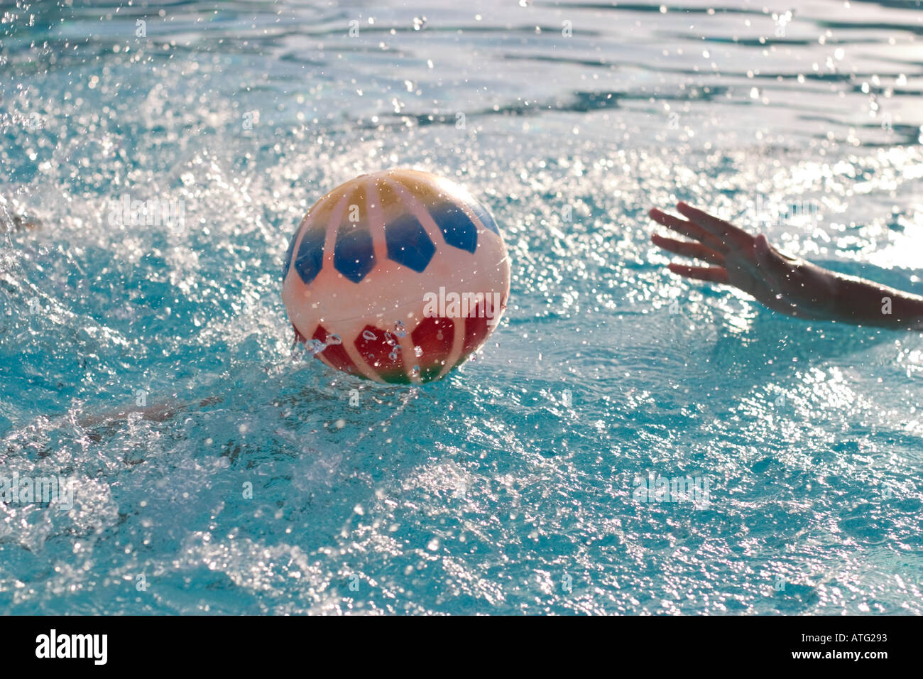 Hand Reaching for Beach Ball in Swimming Pool Stock Photo Alamy