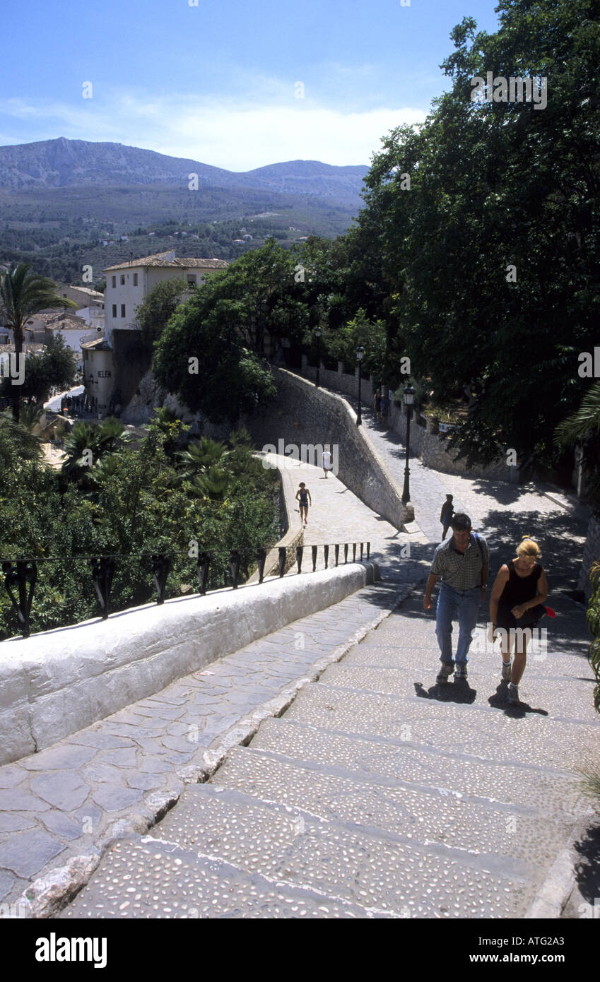 Couple climbing steps Guadalest Spain Stock Photo