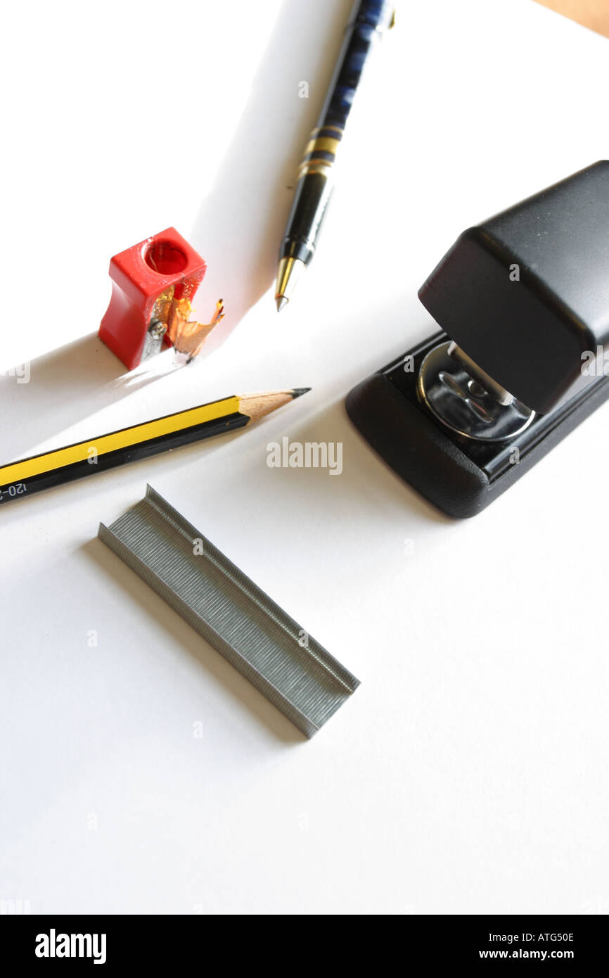 Basic essential office equipment pen pencil sharpener stapler staples Stock Photo