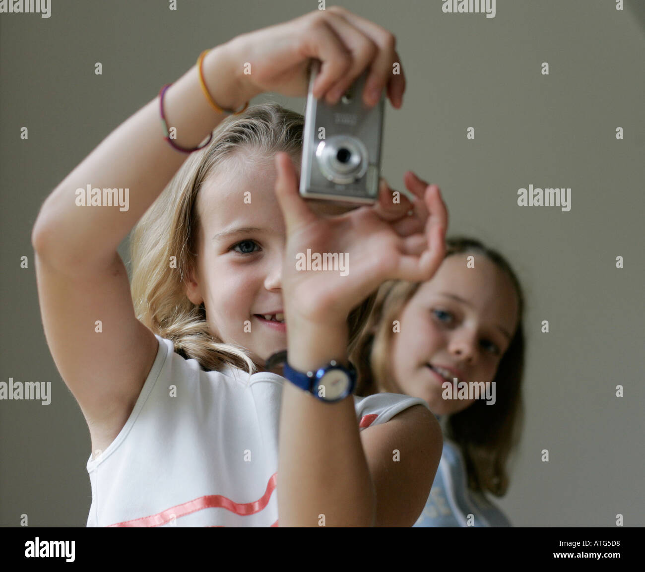 girls take photos with a digital camera Stock Photo