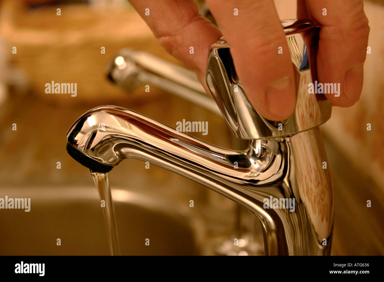 Turning off a kitchen water tap Stock Photo Alamy