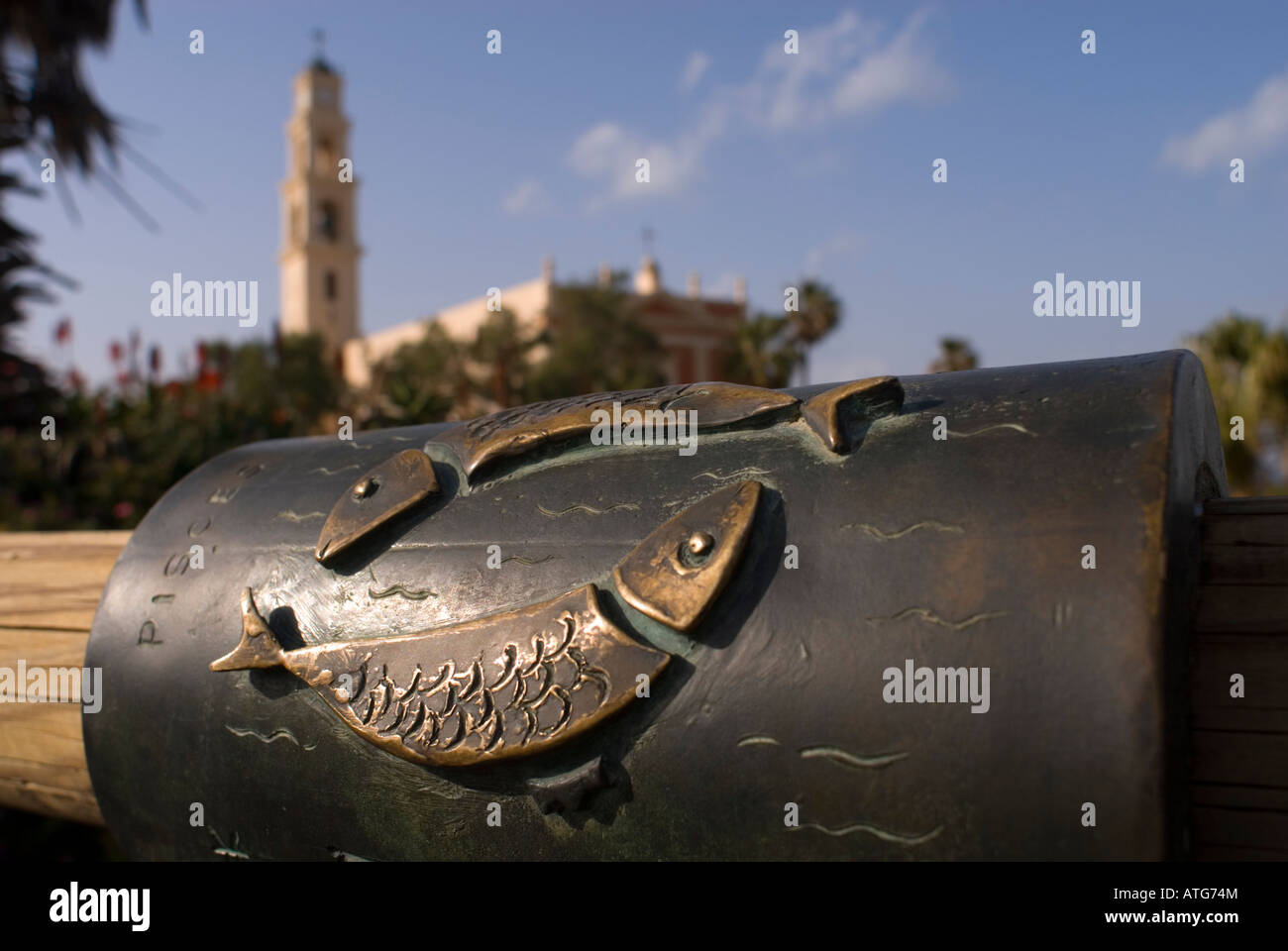 Relief of the Pisces astrological sign in the banister of the 'Wishing Bridge' with St Peter church in background, Old Jaffa Israel Stock Photo