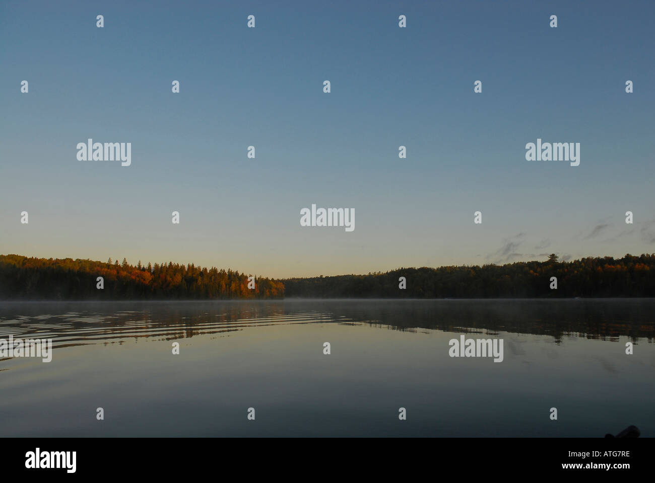 Stock image of st. john river with water like glass on an early fall morning with mist in New Brunswick Canada Stock Photo