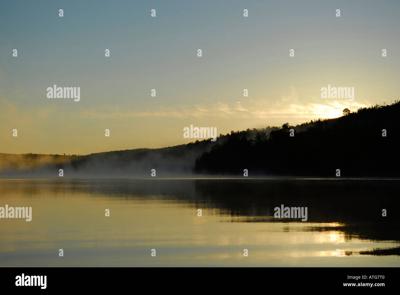 Stock image of st.john river with water like glass on an early fall morning with mist in New Brunswick Canada Stock Photo