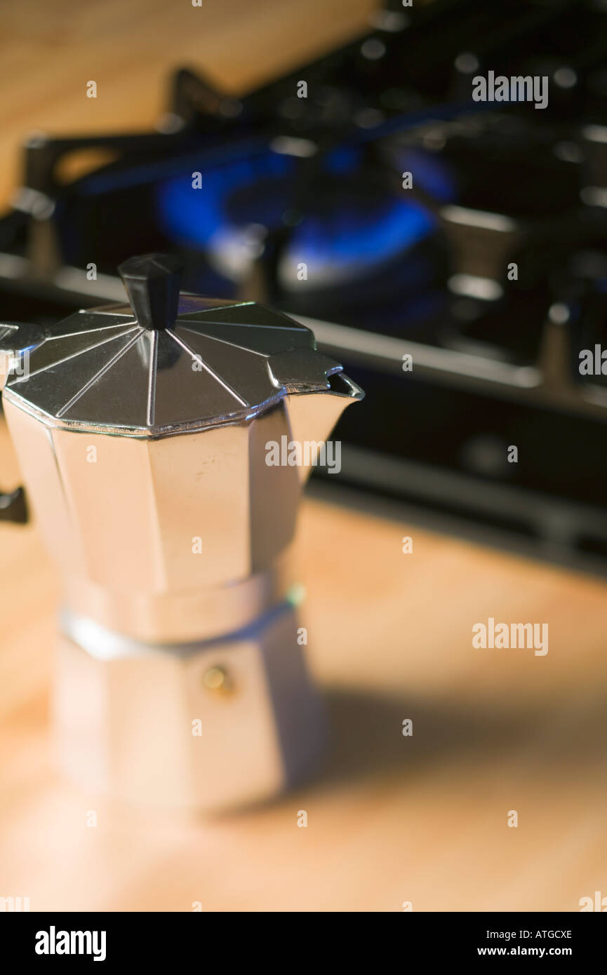 Heating up espresso coffee in a Cuban coffee maker using a mini gas stove  with a Coleman propane tank on a single burner. A thunderstorm is  approaching Stock Photo - Alamy