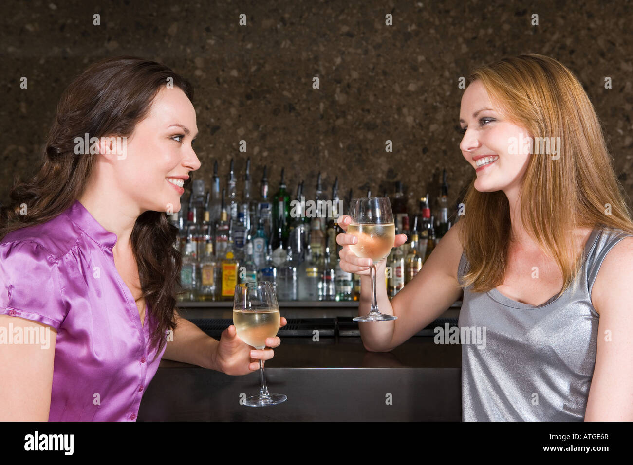 Two women drinking in a bar Stock Photo