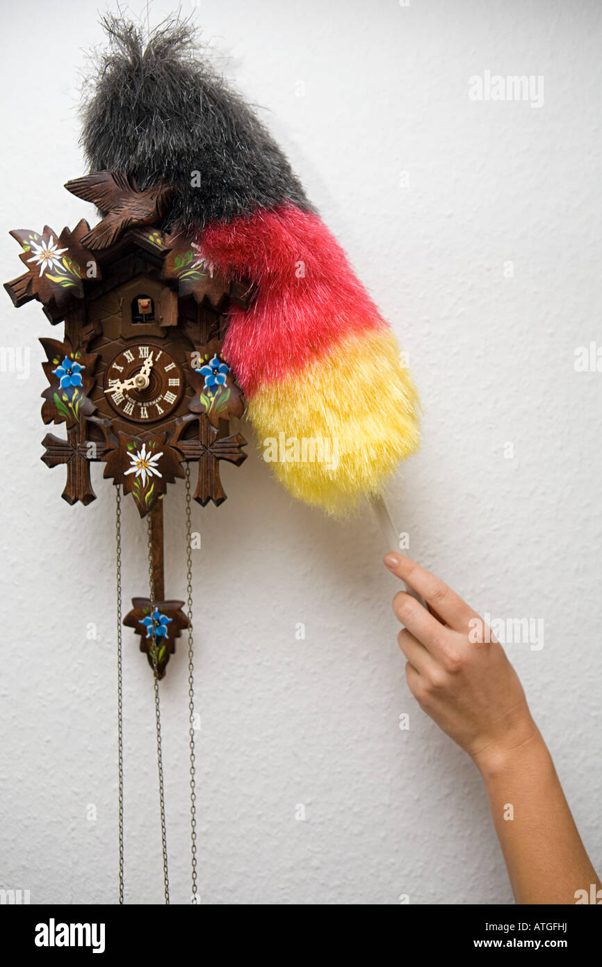 A person cleaning a cuckoo clock Stock Photo Alamy