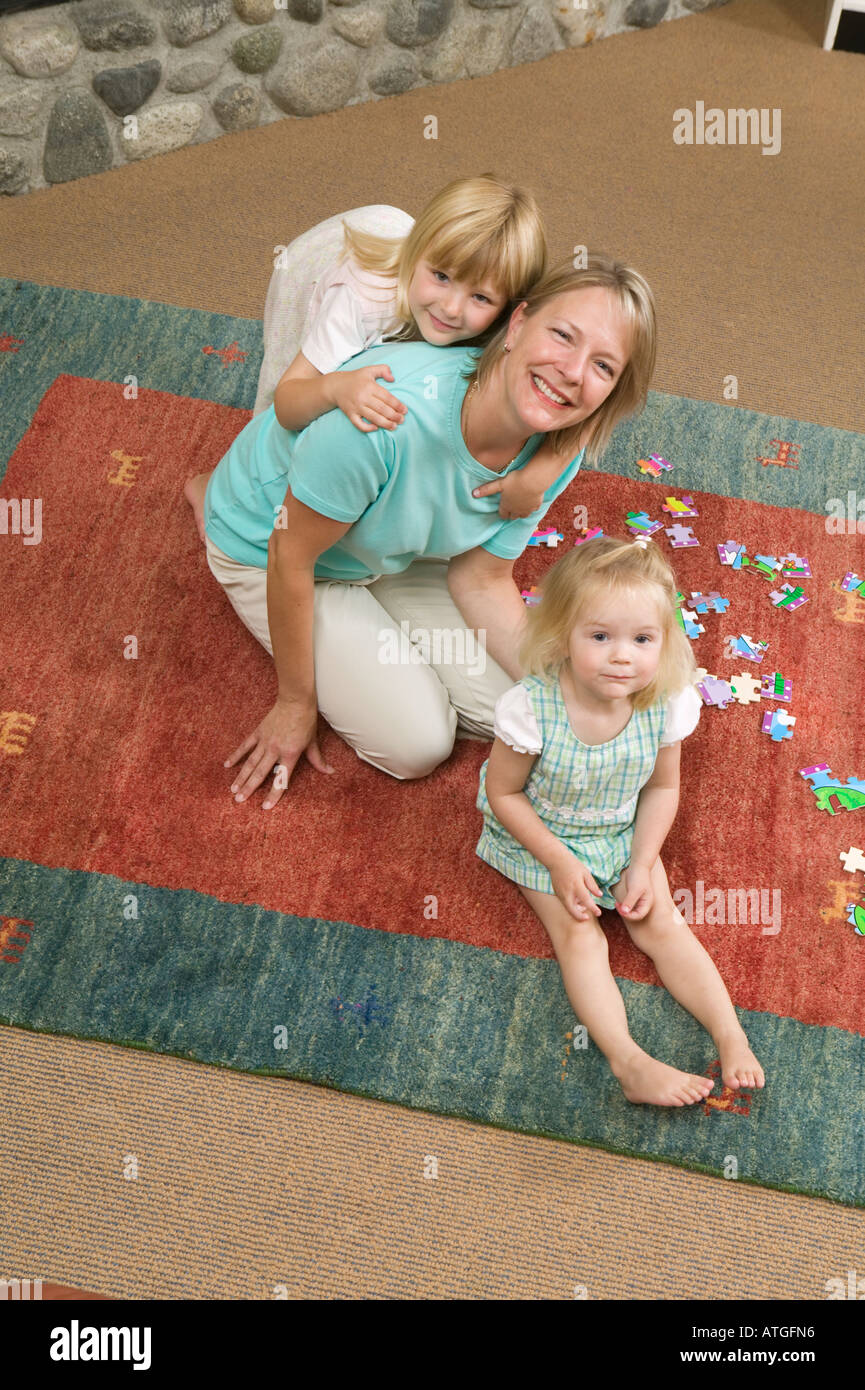 Mom and Daughters With a Jigsaw Puzzle Stock Photo Alamy