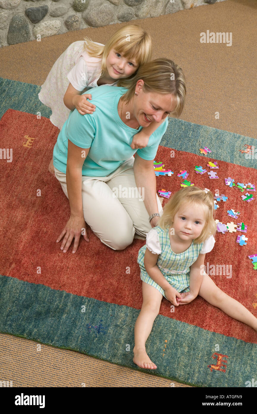 Mom and Daughters With a Jigsaw Puzzle Stock Photo Alamy