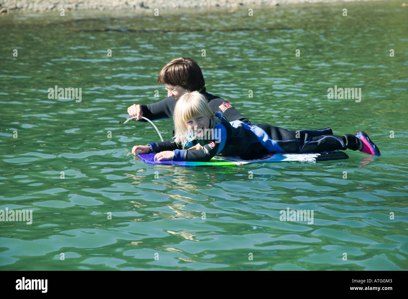 Mom and Daughter Wearing Wetsuits in Cold Water Stock Photo Alamy
