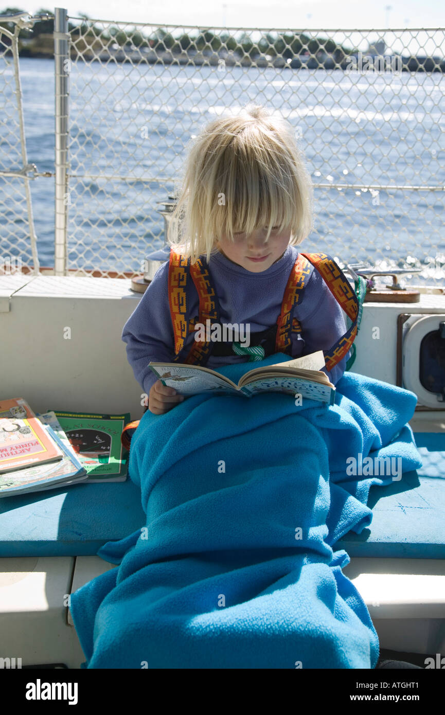 Young Girl Reading on a Boat Stock Photo