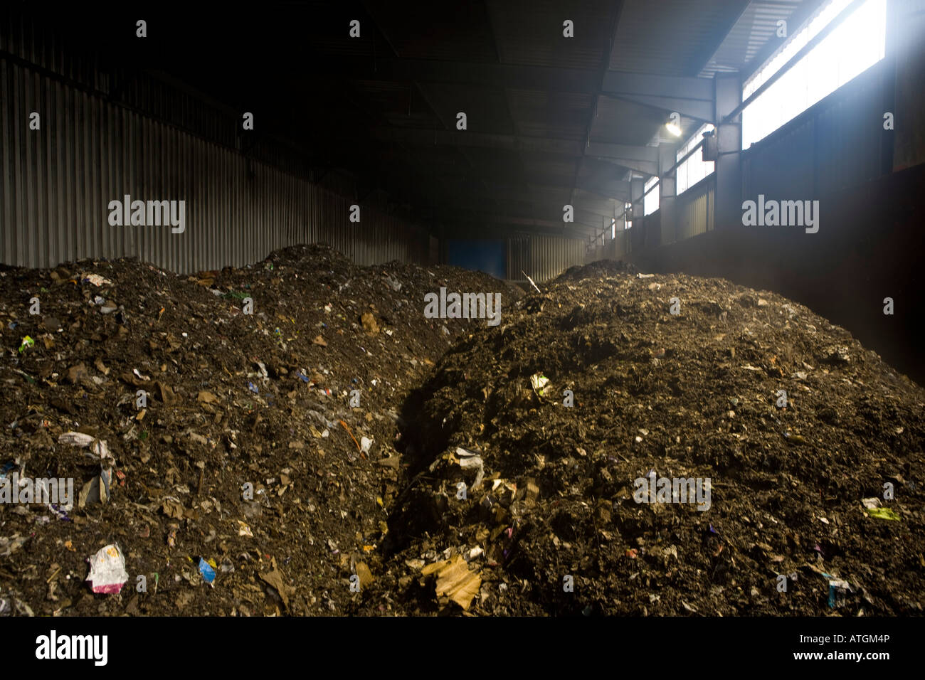 composted household residual waste inside massive composters at New