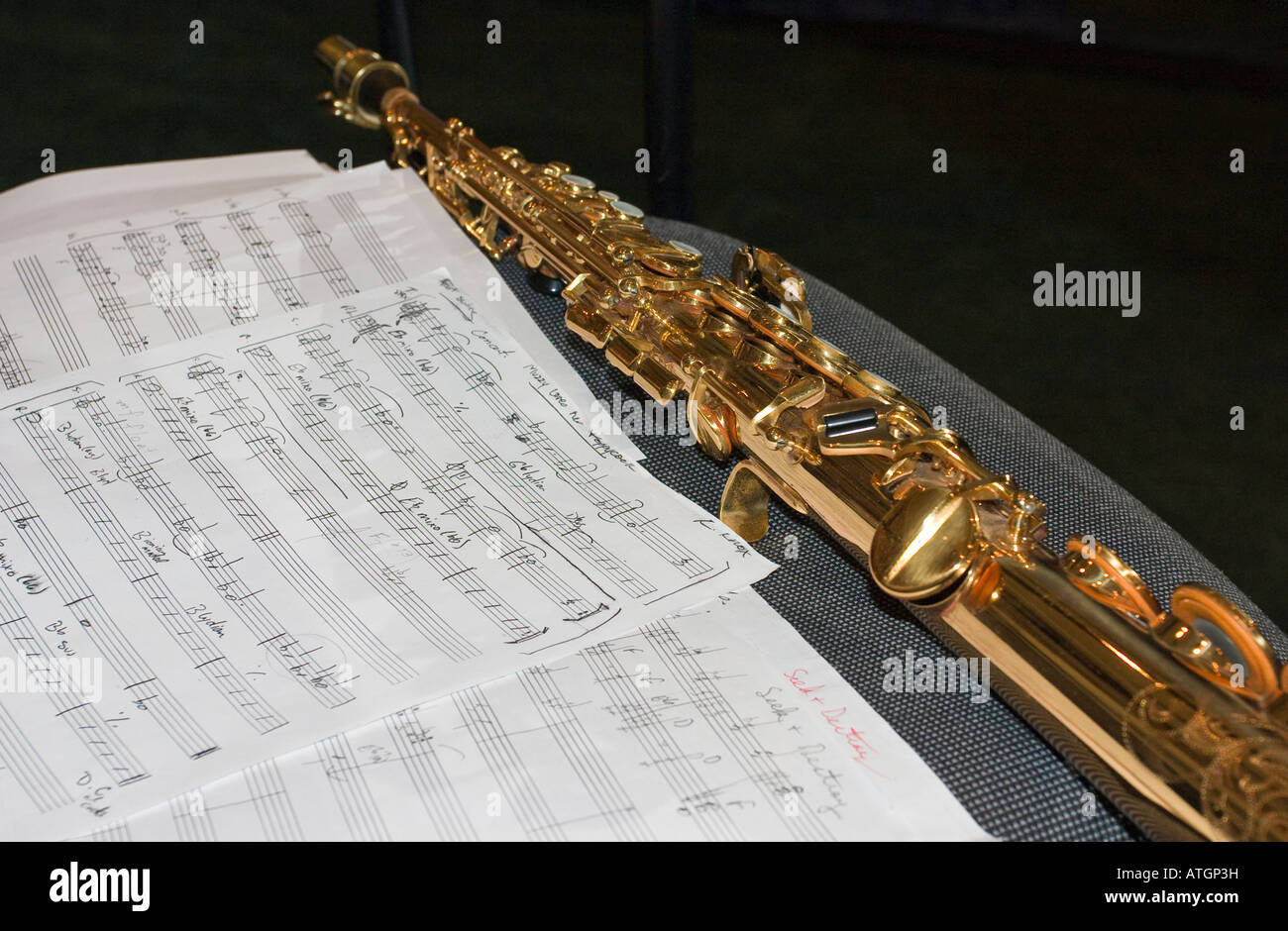 Soprano Saxophone with music A brass straight soprano saxophone with hand written sheet music for a swing jazz band Stock Photo