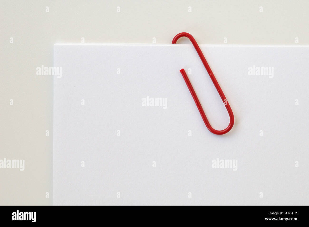 Red paperclip on white paper Stock Photo Alamy