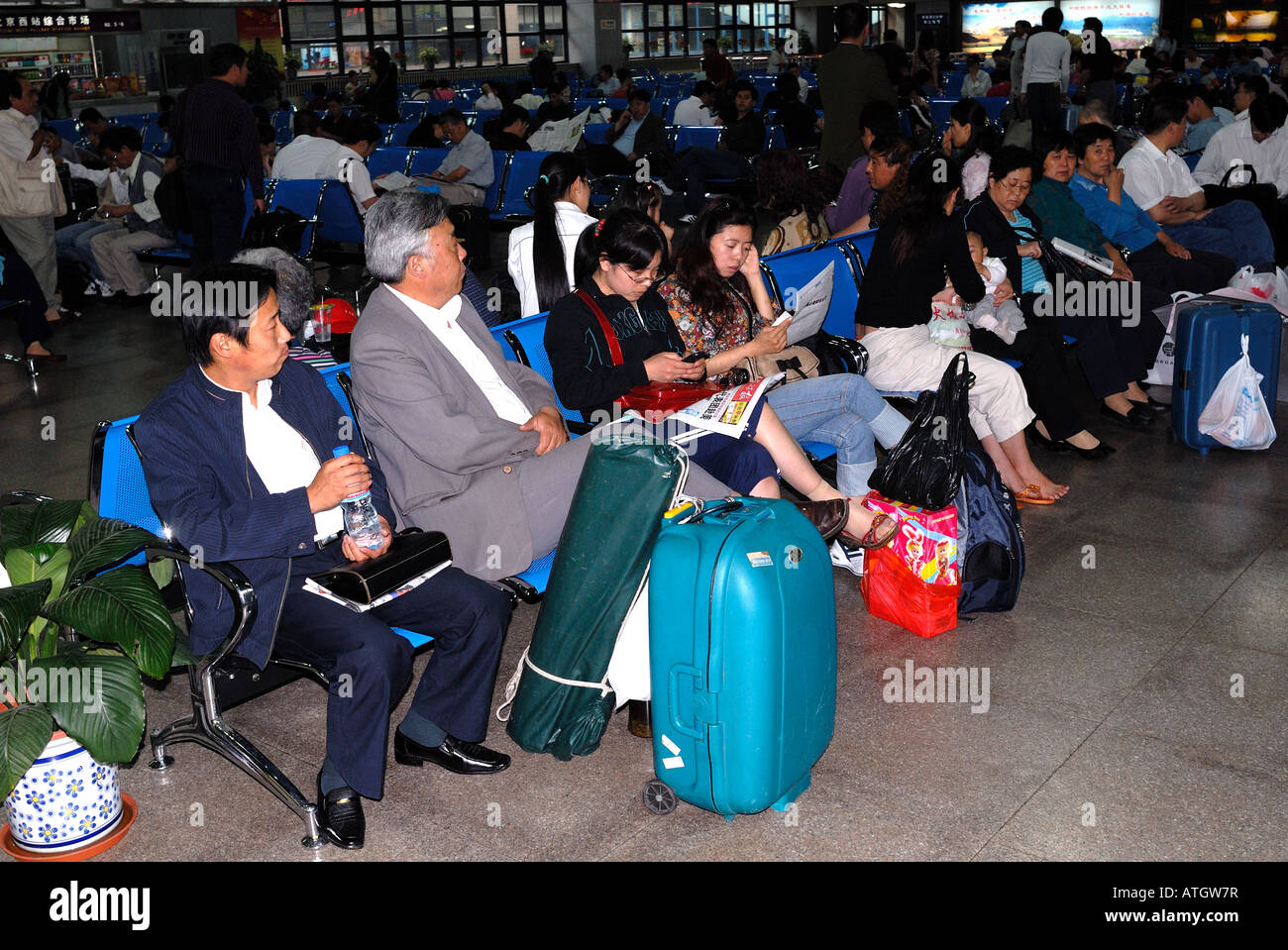 Passengers waiting in the departure lounge for the train to Zhengzhou at Beijing West railway station China Asia Beijing Peking Stock Photo