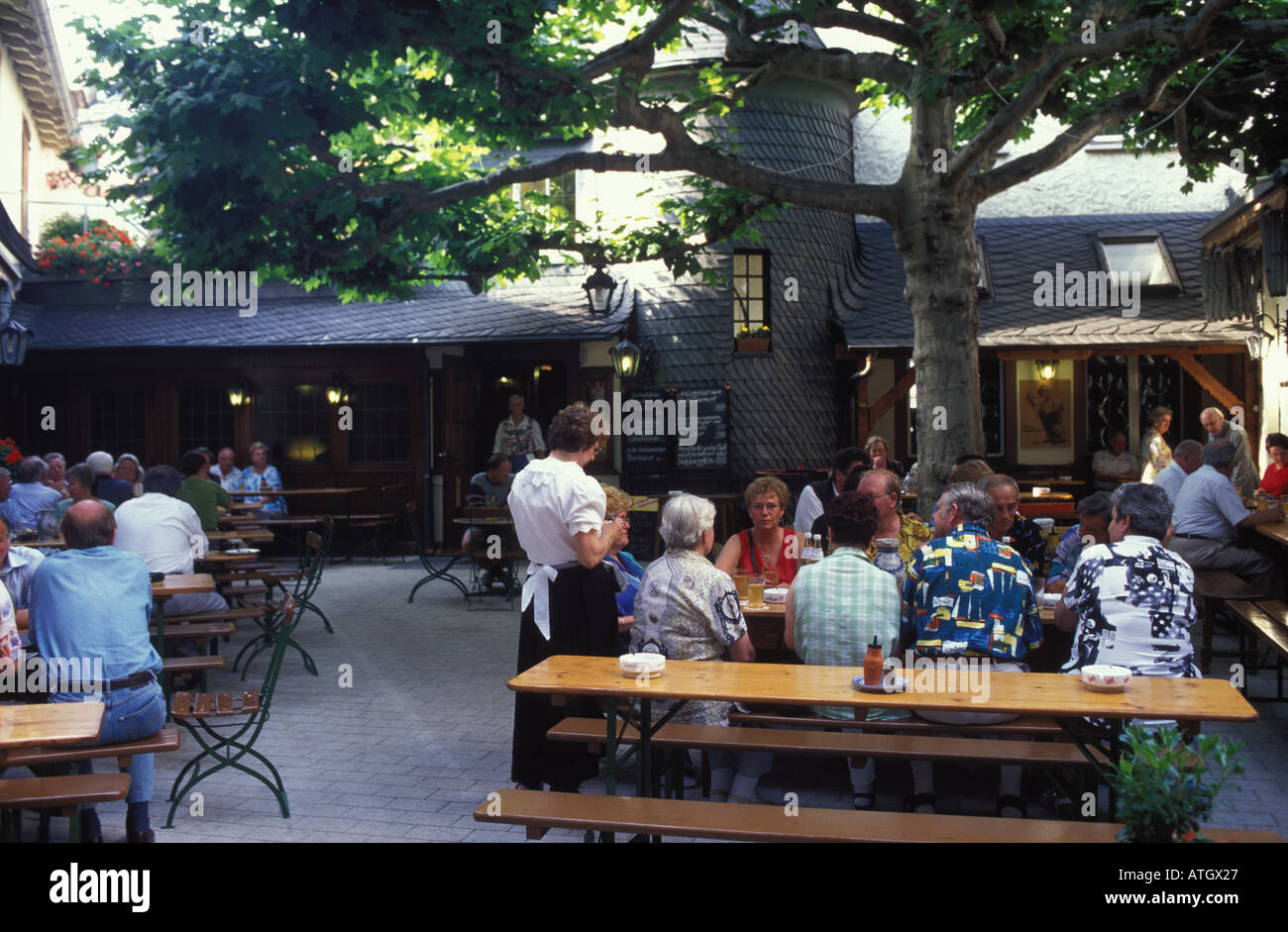 People at the terracce of the cider restaurant pub Klaane Sachsehaeuser Frankfurt Hesse Germany Stock Photo