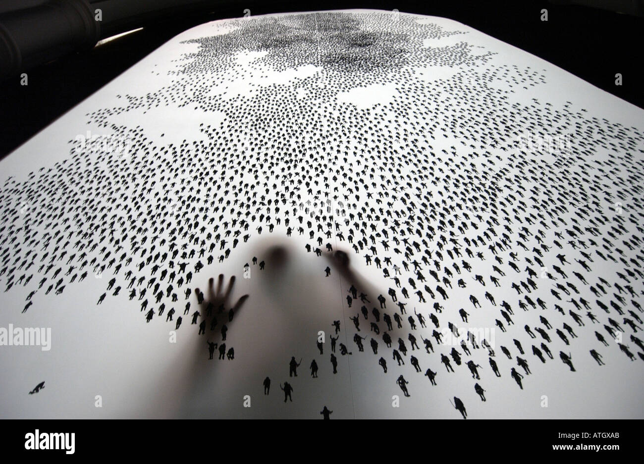 Artist painstakingly draws ten thousand tiny human figures on a screen Stock Photo