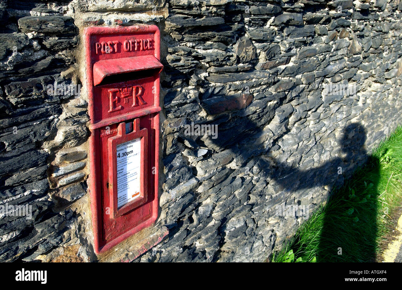 Postbox built into an old slate wall in the seaside fishing village of Port Gaverne near Port Isaac North Cornwall Stock Photo